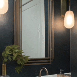 Modern bathroom with hanging lights, a sink, and a plant.