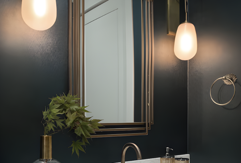 Modern bathroom with hanging lights, a sink, and a plant.