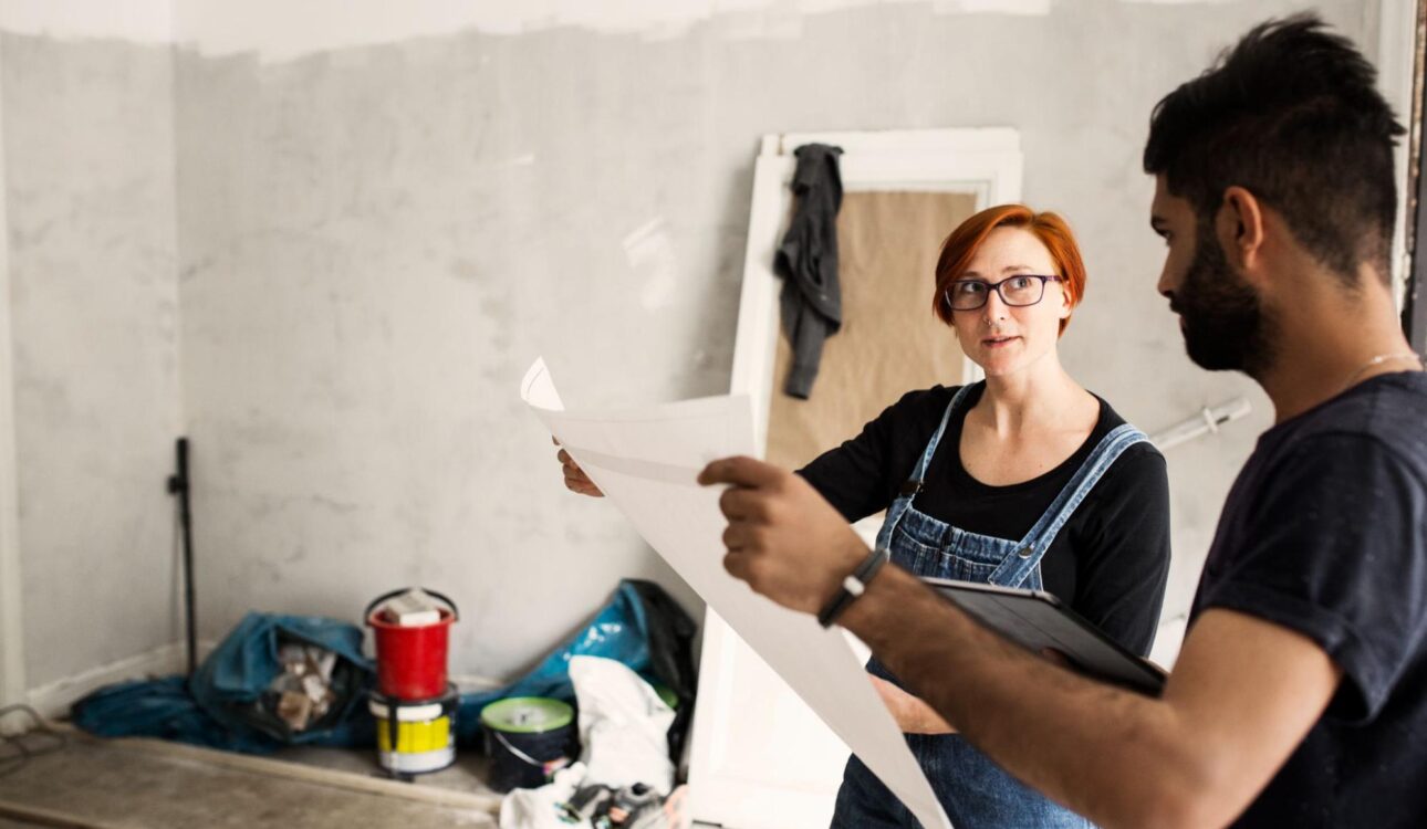 Man and a woman looking at a blueprint.