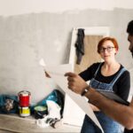 Man and a woman looking at a blueprint.