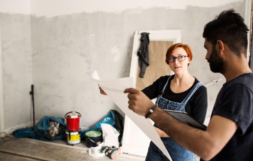 Man and a woman looking at a blueprint.