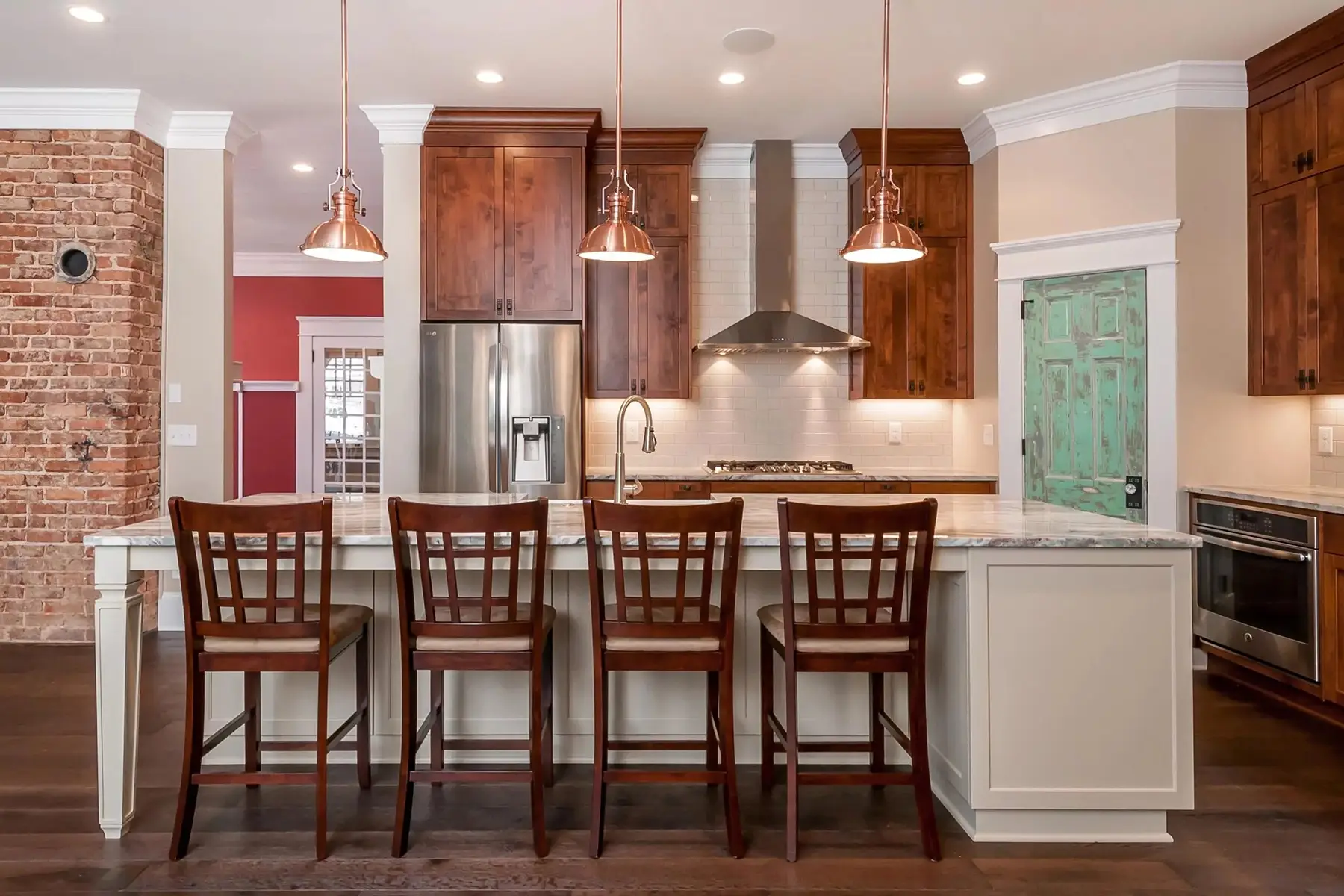Brunswick Pike, Lambertville, NJ 08530 3 | The Home X Open kitchen with brick backsplash, wood cabinetry, and large island seating in Lambertville, NJ