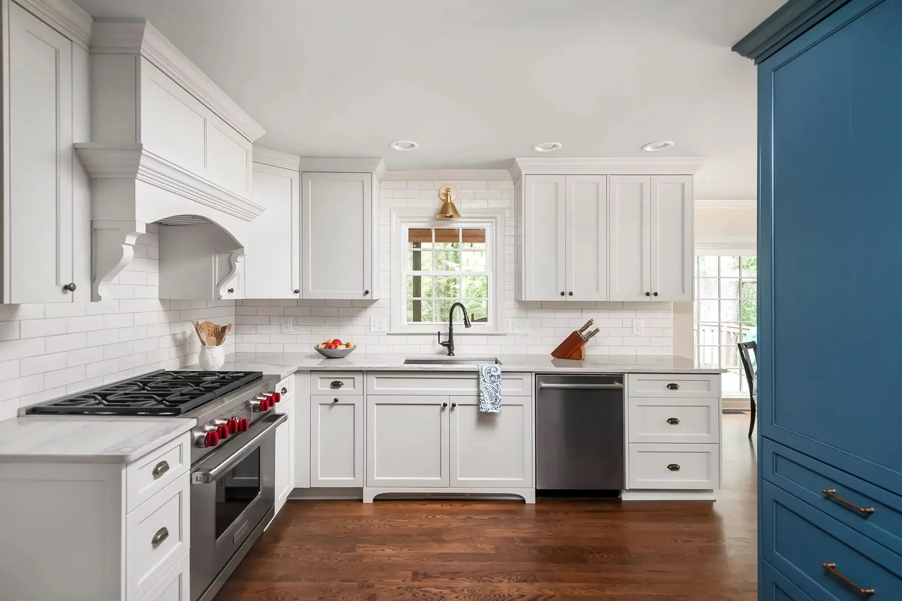Pineville Rd, Newtown, PA 18940 1 | The Home X Bright white kitchen with shaker cabinets, blue island, and pendant lighting.