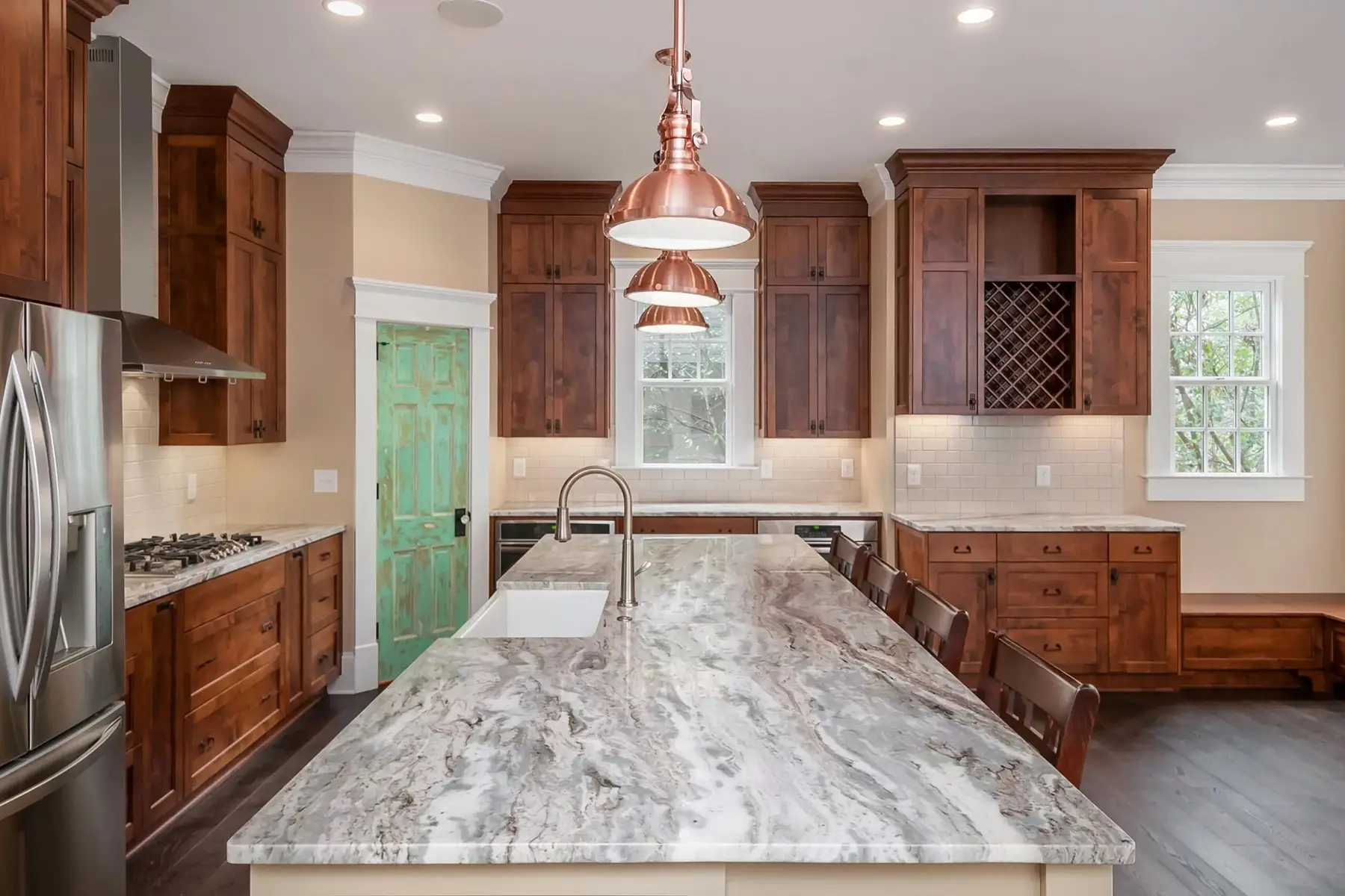 Brunswick Pike, Lambertville, NJ 08530 5 | The Home X Kitchen island with granite countertop, wood cabinetry, and copper pendant lights in Lambertville, NJ