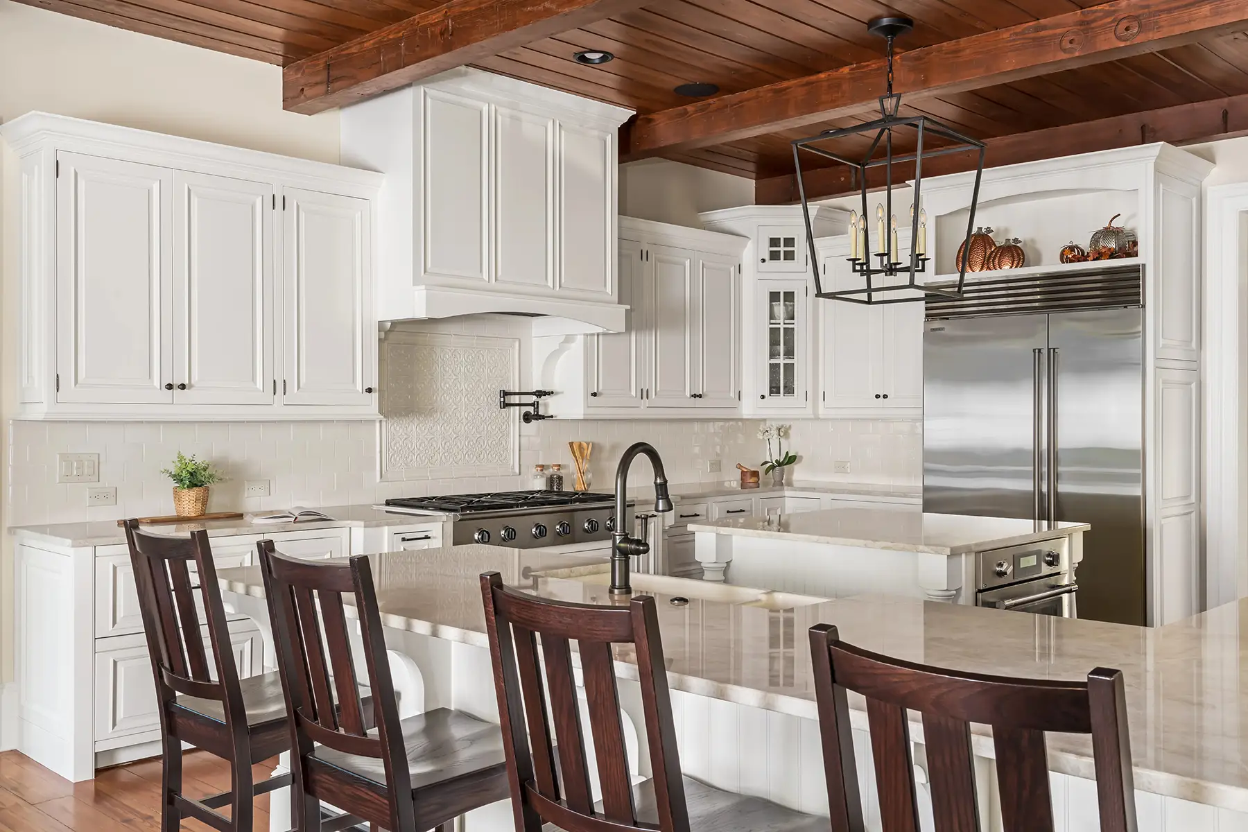 Woodhill Rd, Newtown, PA 18940 2 | The Home X Bright kitchen with exposed beams, white cabinetry, and dark wood island seating in Newtown, PA remodel.