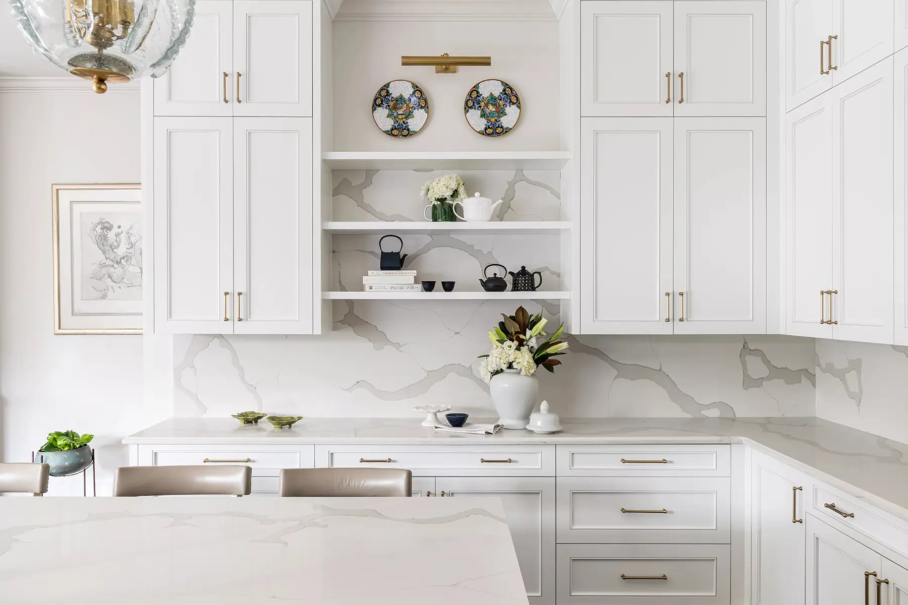 Moore St, Princeton, NJ 08540 4 | The Home X Bright white kitchen with integrated range hood, floating wood shelves, and marble backsplash.