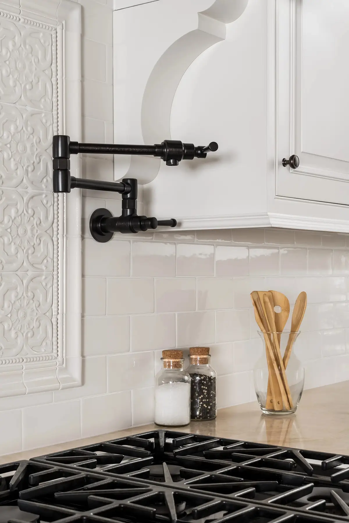 Woodhill Rd, Newtown, PA 18940 4 | The Home X Close-up of a white kitchen backsplash with matte black pot filler and geometric black-and-white countertop in Newtown, PA.