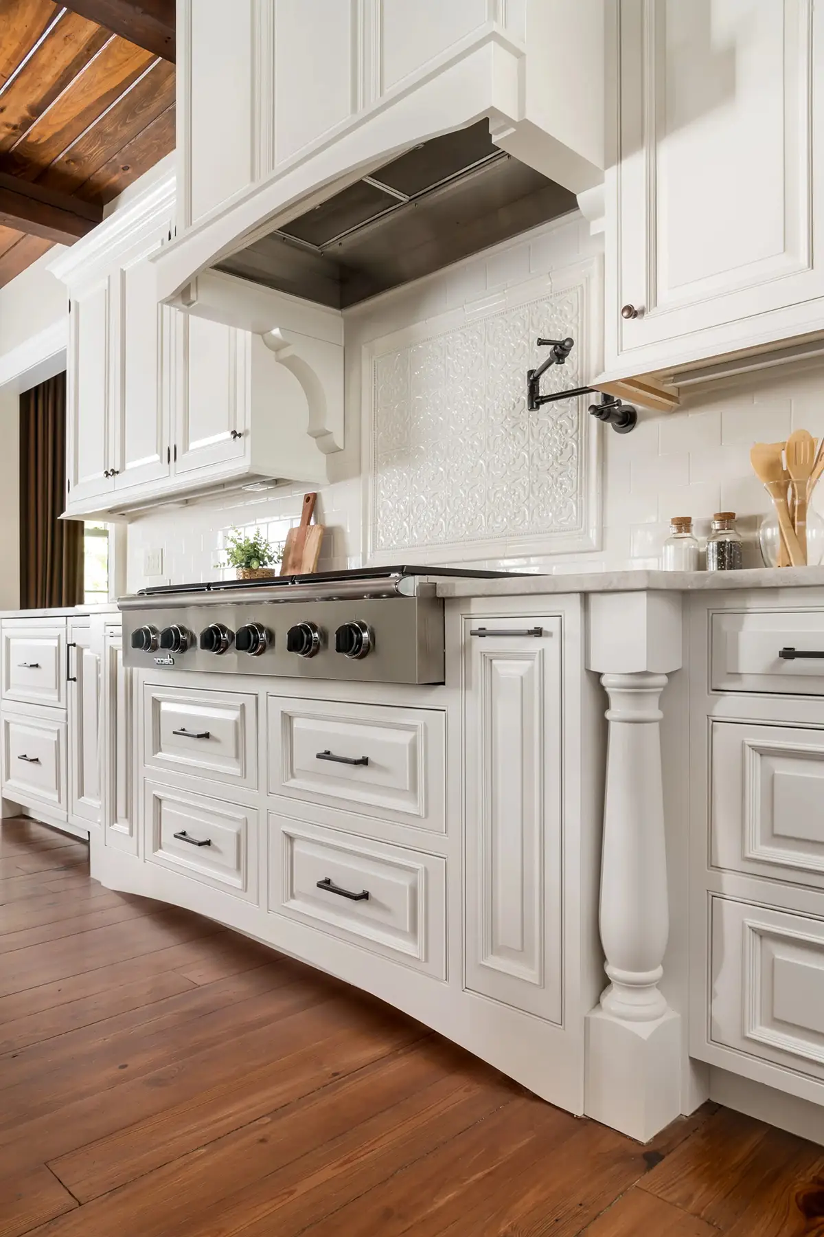 Woodhill Rd, Newtown, PA 18940 5 | The Home X Custom white kitchen with wood range hood, stainless steel stove, and shaker cabinets in Newtown, PA.