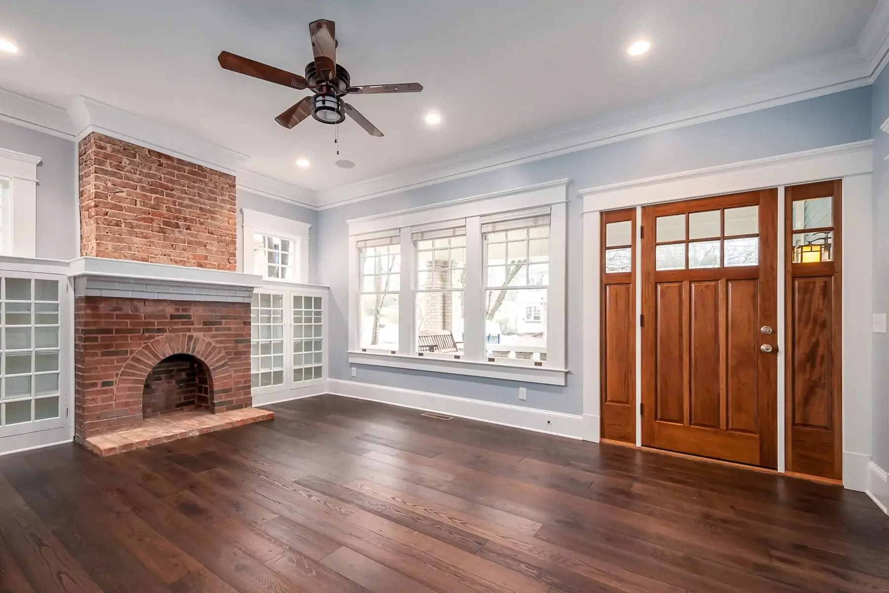 Brunswick Pike, Lambertville, NJ 08530 4 | The Home X Living room with brick fireplace, wood floors, and glass French doors in Lambertville, NJ remodel