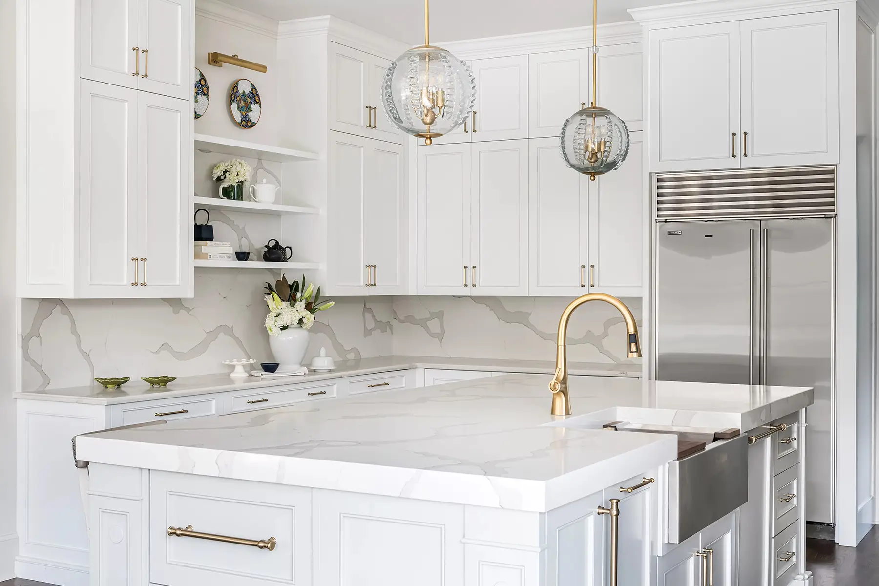 Moore St, Princeton, NJ 08540 5 | The Home X Bright white kitchen with large quartz island, brass sconces, and floating shelves.
