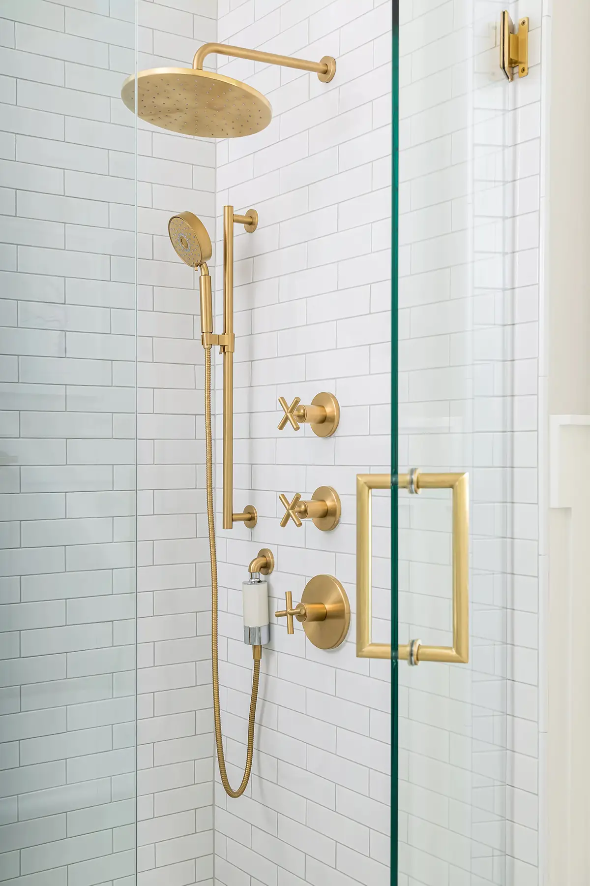 Mt Lucas Rd, Princeton, NJ 08540 8 | The Home X Close-up of modern gold shower fixtures against white textured tile.