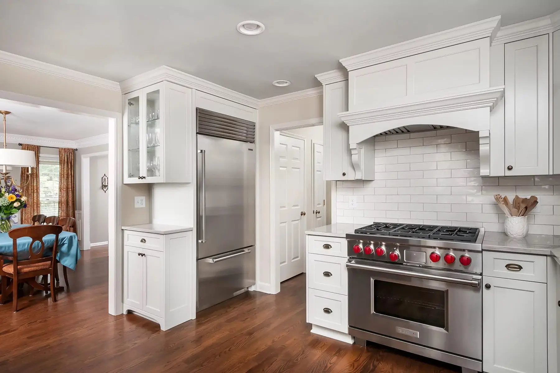 Pineville Rd, Newtown, PA 18940 4 | The Home X Elegant white kitchen with arched vent hood and modern pendant lighting.