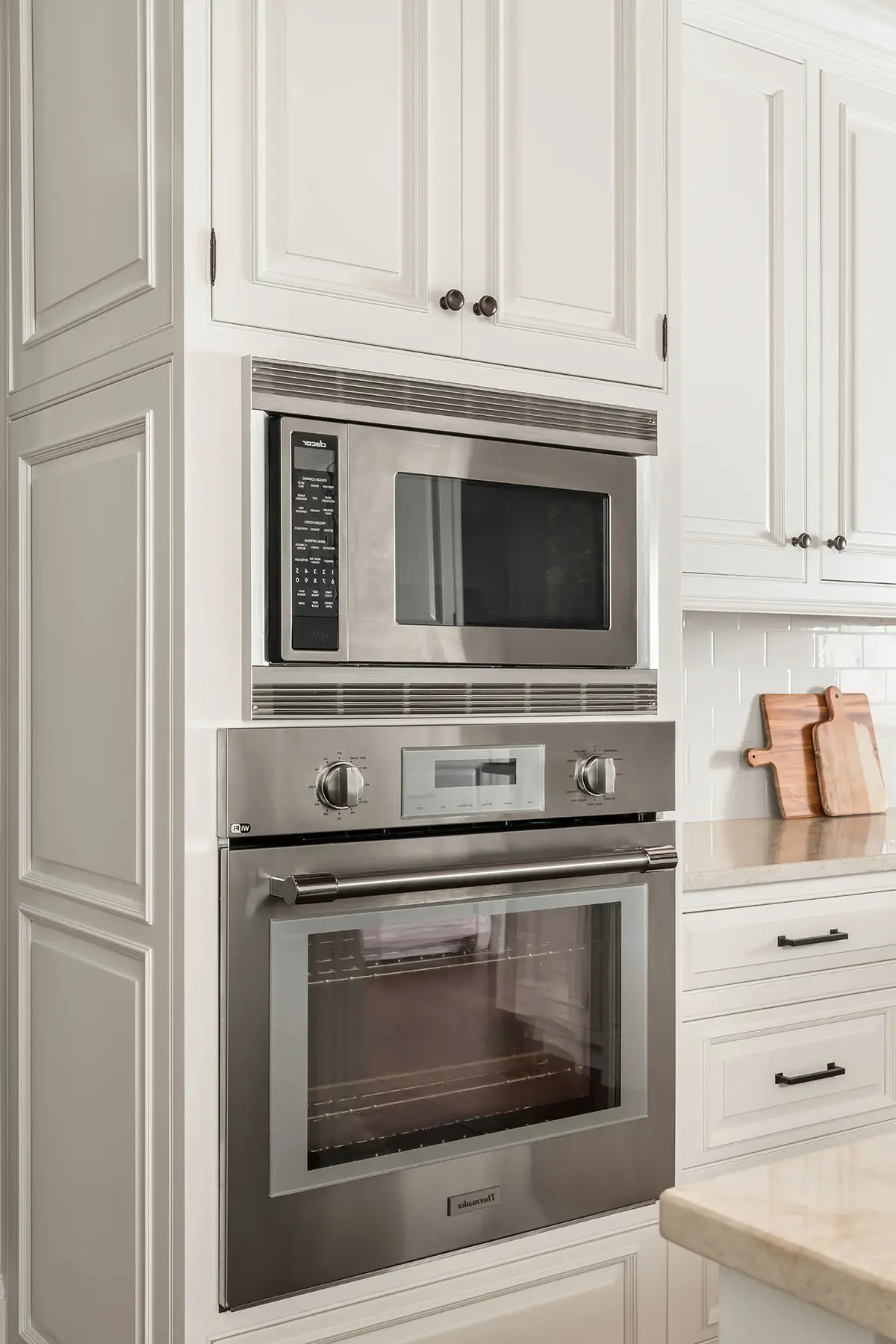 Woodhill Rd, Newtown, PA 18940 9 | The Home X Built-in wall oven and microwave combo in white cabinetry with brushed nickel hardware.