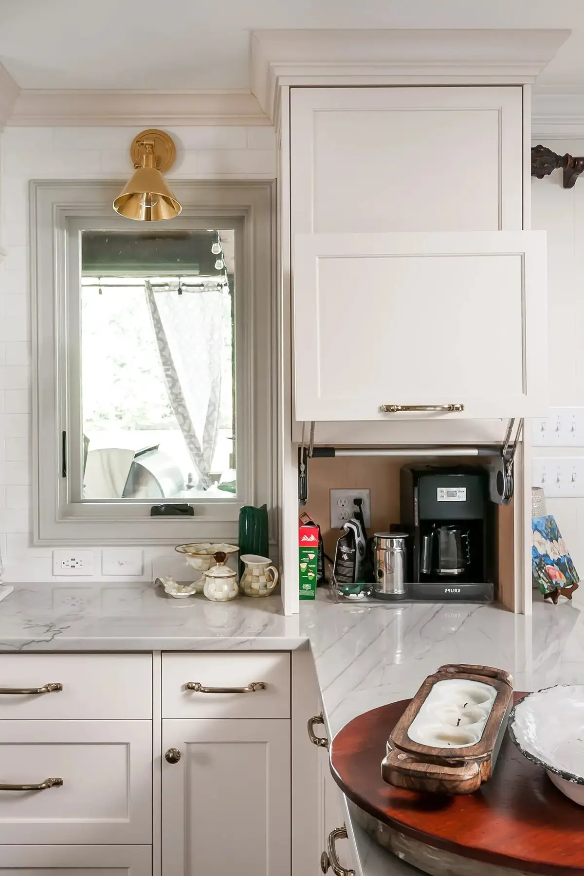Lake Dr, Princeton, NJ 08540 10 | The Home X Small beverage station with floating shelves, white cabinetry, and brass sconce in Princeton, NJ remodel