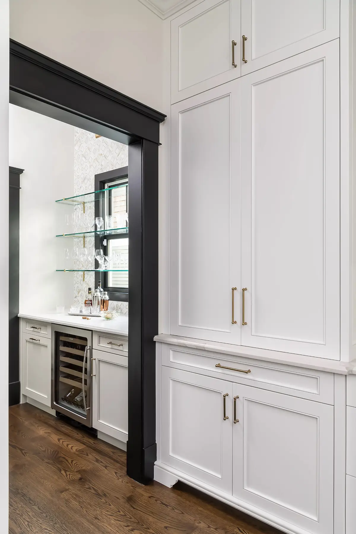 Moore St, Princeton, NJ 08540 15 | The Home X Tall white built-in pantry cabinets with integrated paneling and adjacent beverage bar.