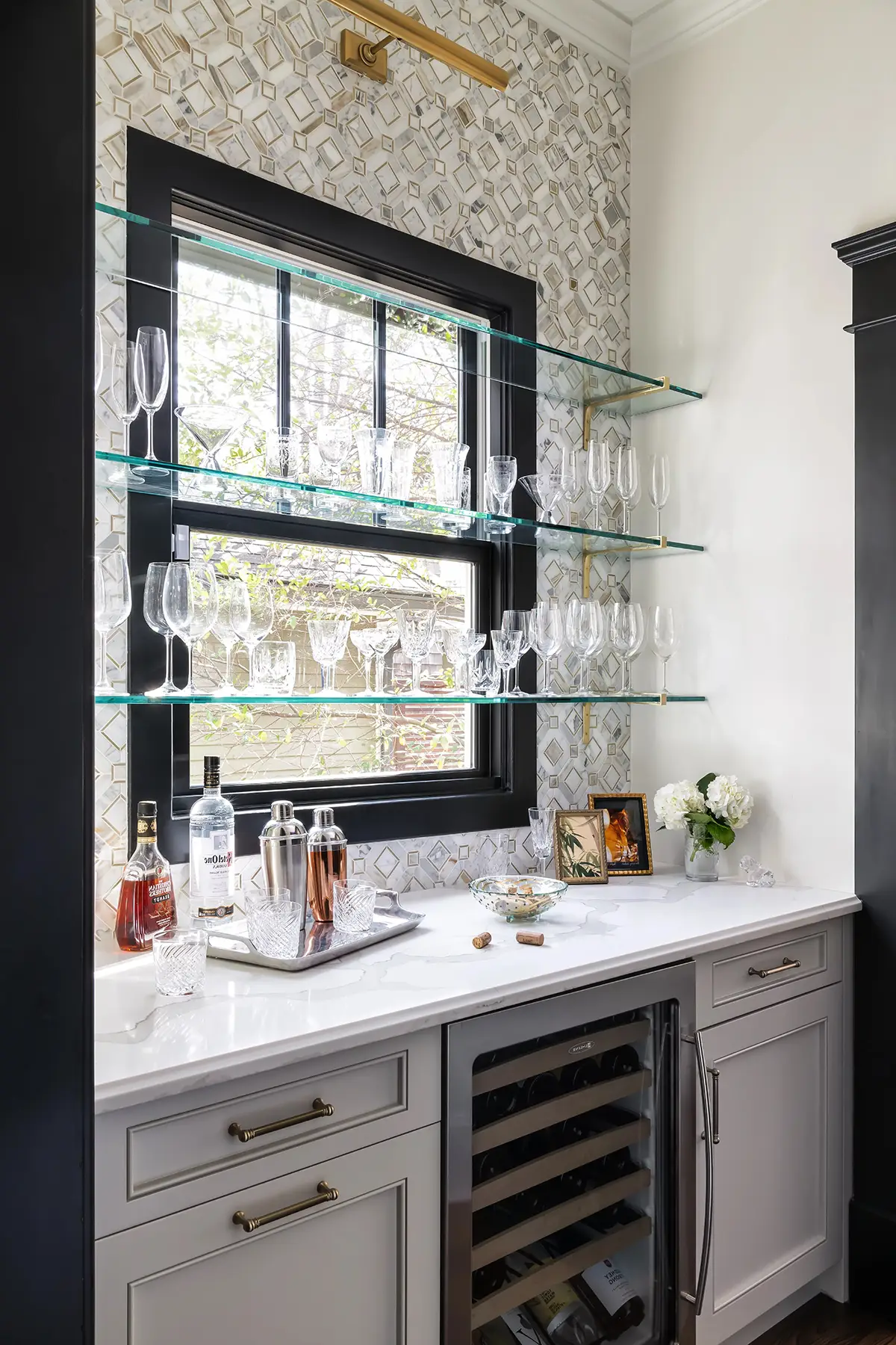 Moore St, Princeton, NJ 08540 17 | The Home X Modern black and glass bar nook with open shelving and built-in beverage cooler.