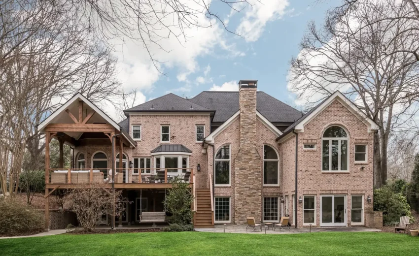 Expansive stone estate home with gabled rooflines, arched windows, and a manicured lawn in New Hope, Pennsylvania.