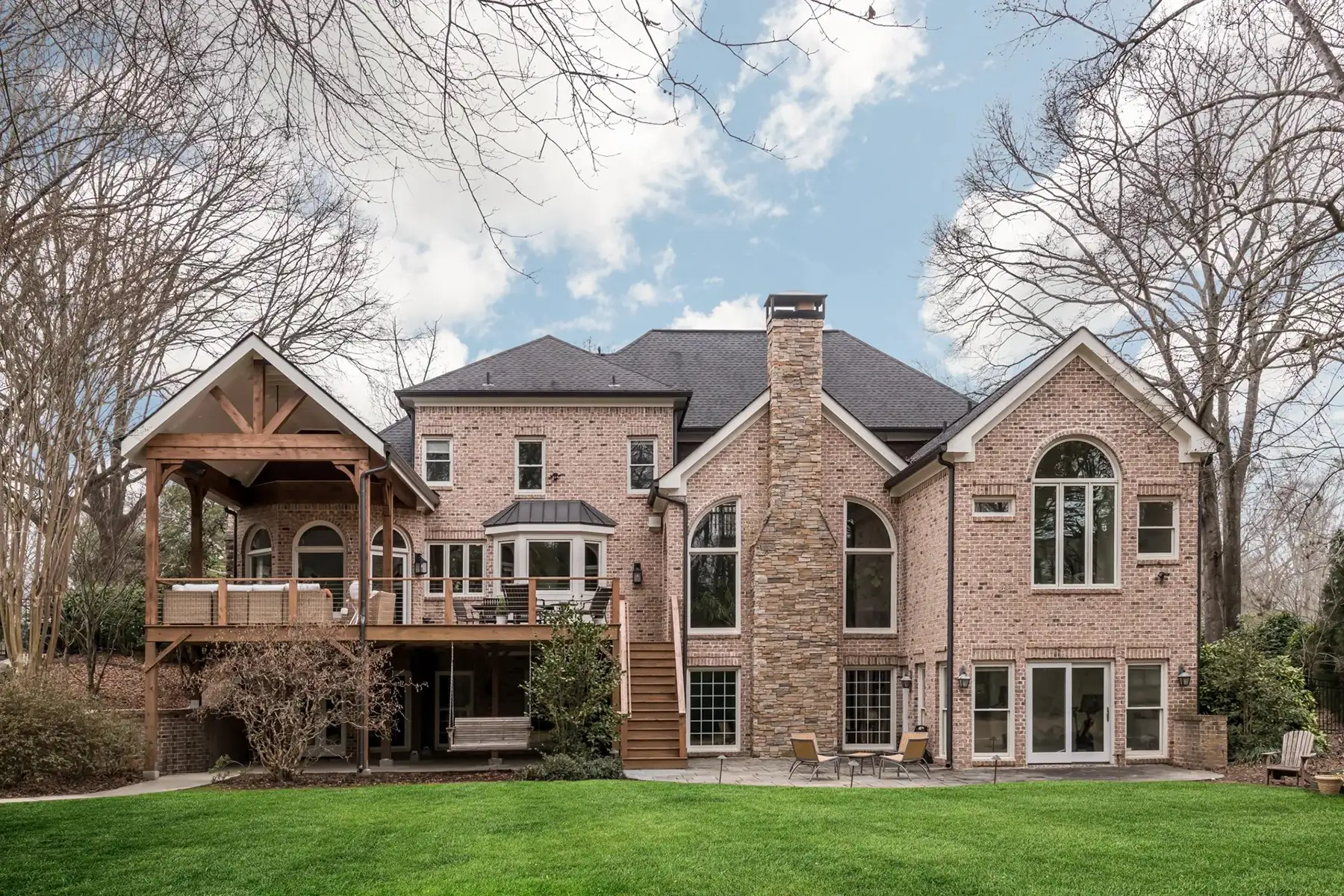 Aquetong Rd, New Hope, Pa 18938 1 | The Home X Expansive stone estate home with gabled rooflines, arched windows, and a manicured lawn in New Hope, Pennsylvania.