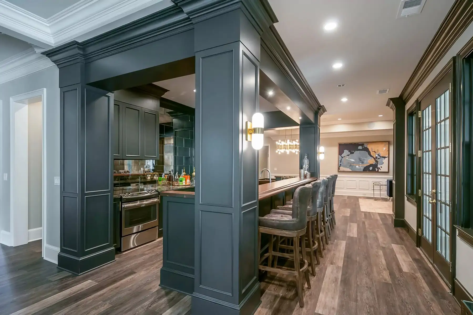 Lower Mountain Rd, New Hope, PA 18938 2 | The Home X Contemporary home bar with sleek cabinetry, under-cabinet lighting, and wide plank hardwood floors in New Hope, PA basement remodel.