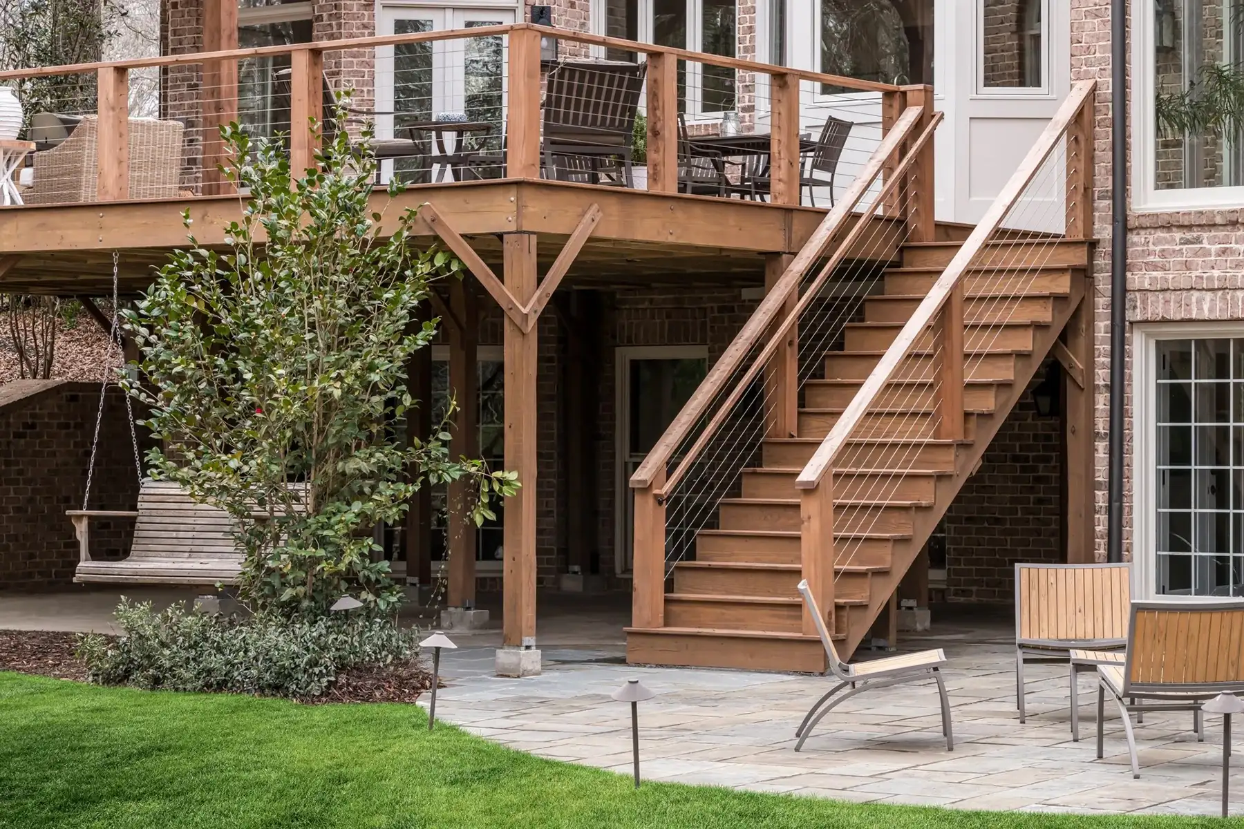 Aquetong Rd, New Hope, Pa 18938 3 | The Home X Timber staircase and stone columns on the rear exterior of a luxury New Hope home with upper and lower deck access.