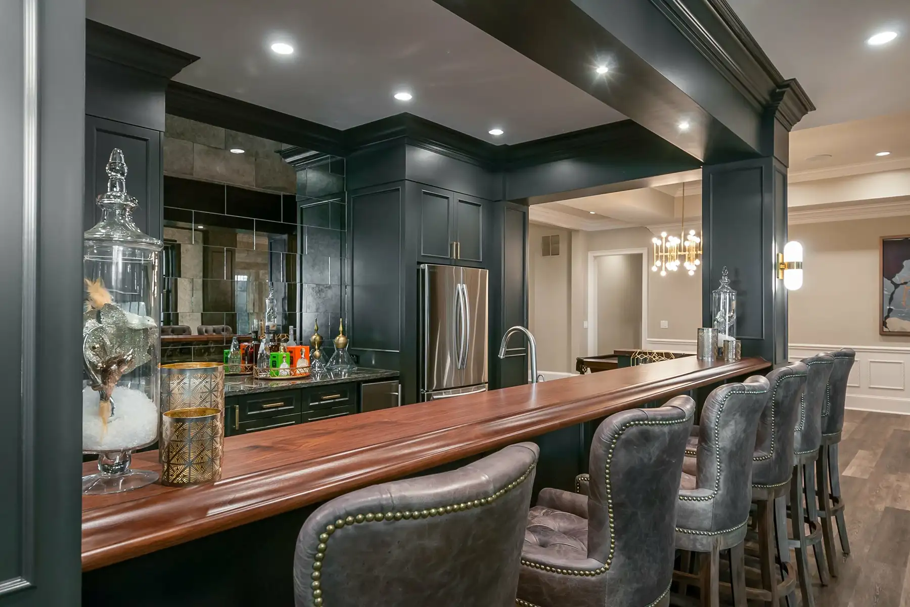 Lower Mountain Rd, New Hope, PA 18938 3 | The Home X Luxury home bar with dark cabinetry, bar seating, and integrated lighting in a New Hope, PA finished basement.