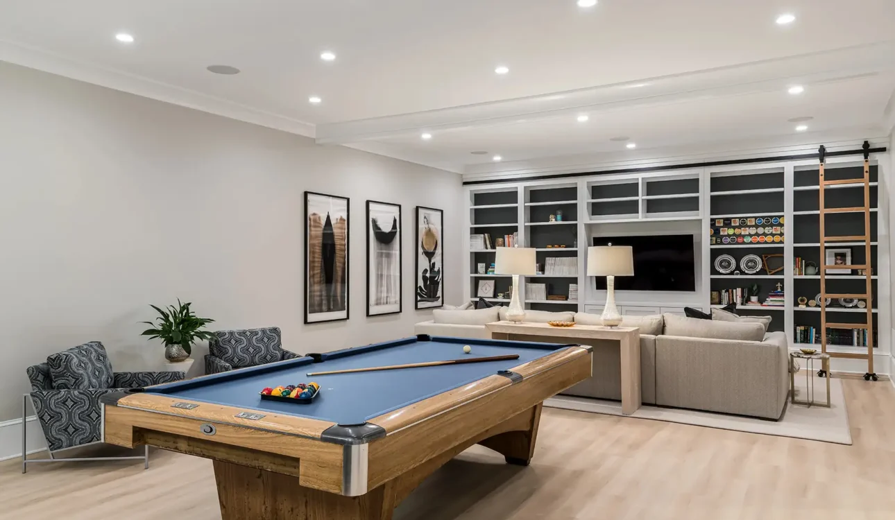 Luxury basement remodel in Newtown, PA featuring custom cabinetry, warm wood tones, and integrated lighting.