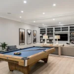 Luxury basement remodel in Newtown, PA featuring custom cabinetry, warm wood tones, and integrated lighting.