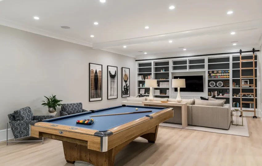 Luxury basement remodel in Newtown, PA featuring custom cabinetry, warm wood tones, and integrated lighting.