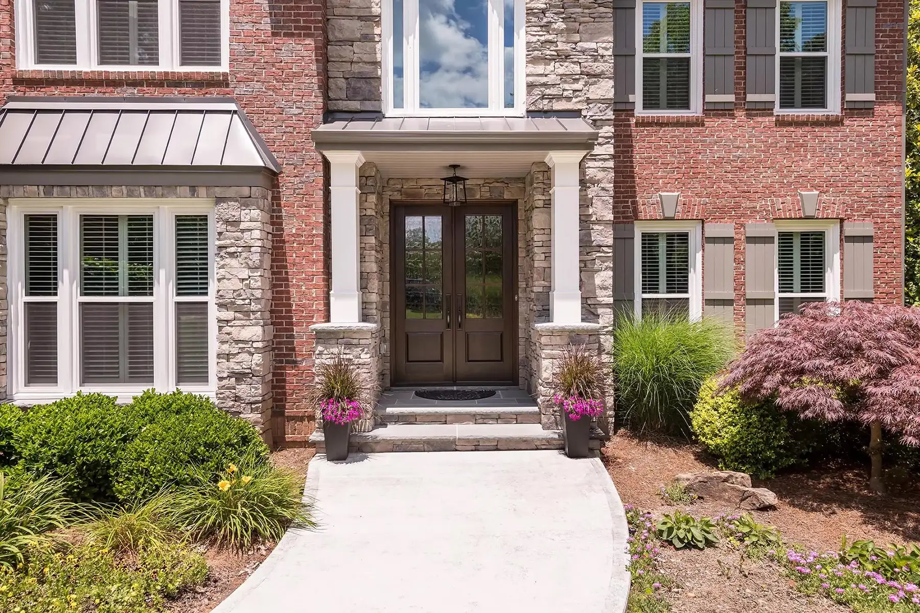 Sugan Rd, New Hope, PA 18938 2 | The Home X Front entrance of traditional brick home with glass-paneled double doors and landscaped walkway.