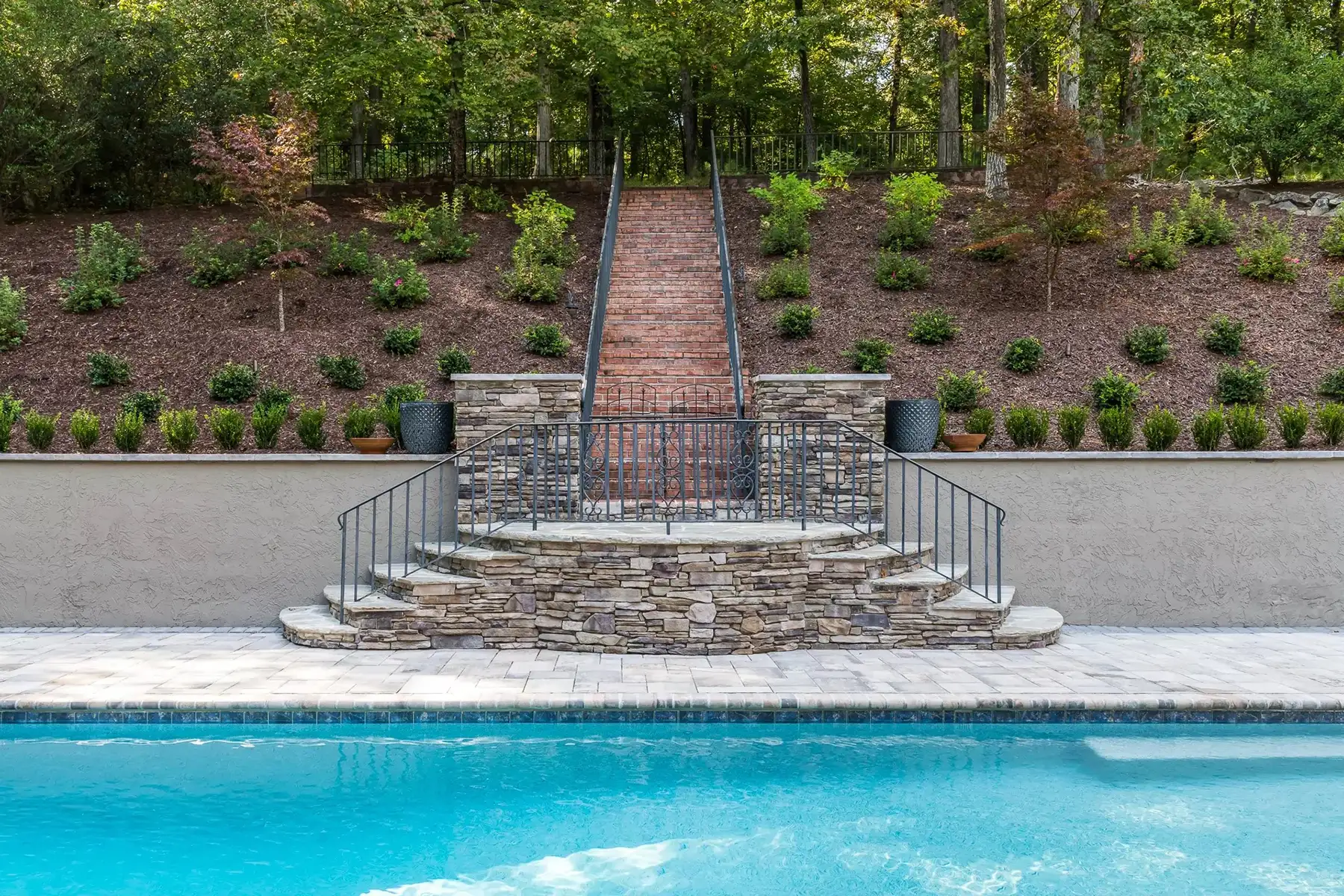 Sergeantsville Rd, Delaware Twp., 08559 4 | The Home X Stone staircase descending to a poolside waterfall with tiered landscaping.