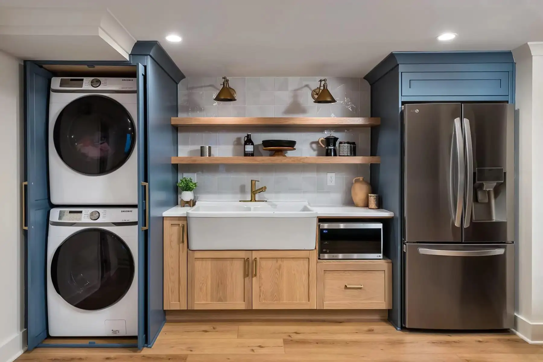 Federal City Rd, Pennington, NJ 08534 8 | The Home X Modern laundry nook with stacked washer and dryer, floating wood shelves, and built-in blue cabinets.