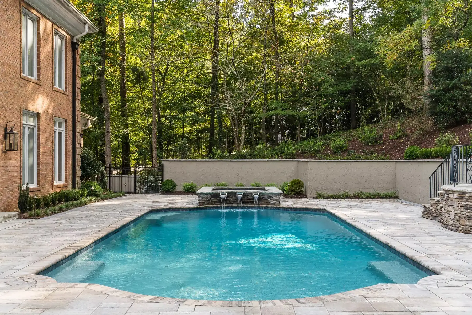 Sergeantsville Rd, Delaware Twp., 08559 6 | The Home X Contemporary in-ground pool with expansive concrete patio and lush woodland views in Delaware Township, NJ.
