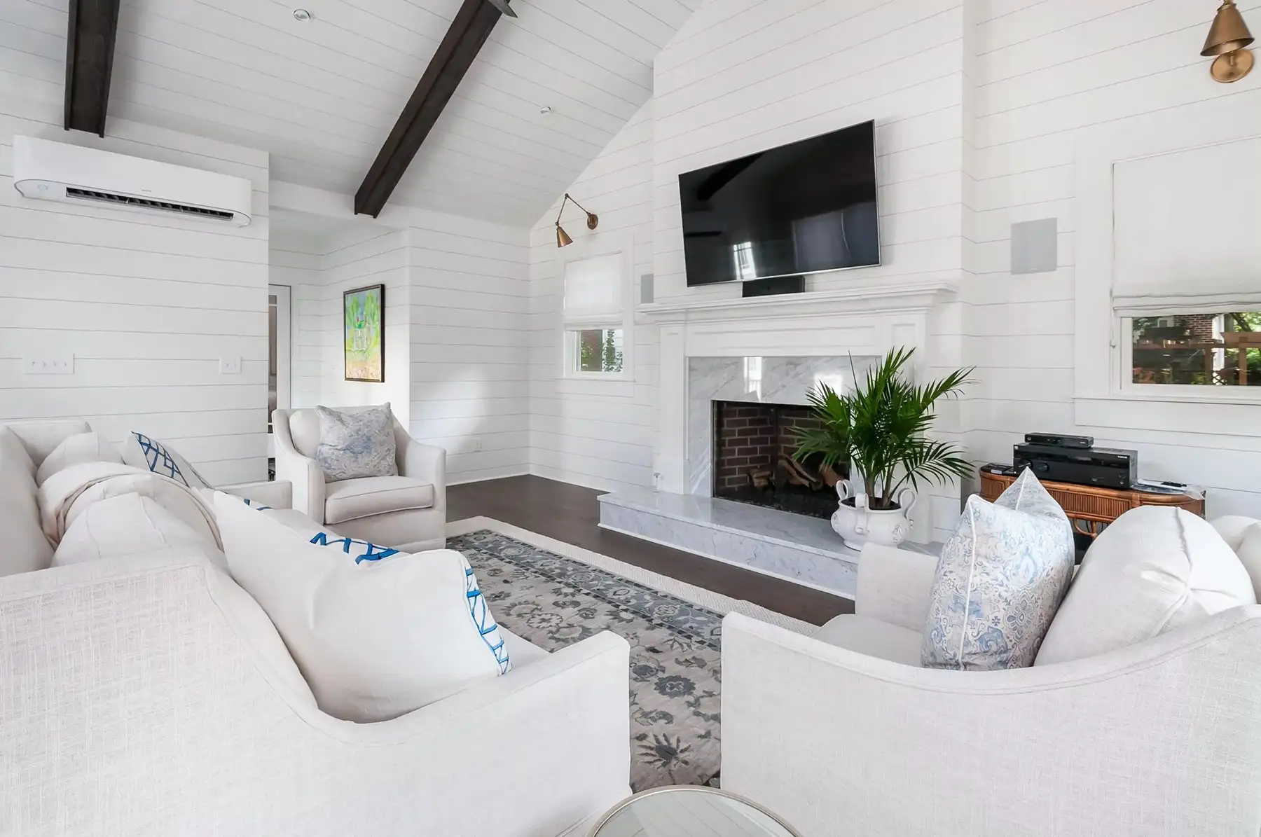 Washington Crossing Pennington Rd, Pennington, NJ 08534 7 | The Home X Bright modern living room with vaulted ceiling, dark beams, and white decor.