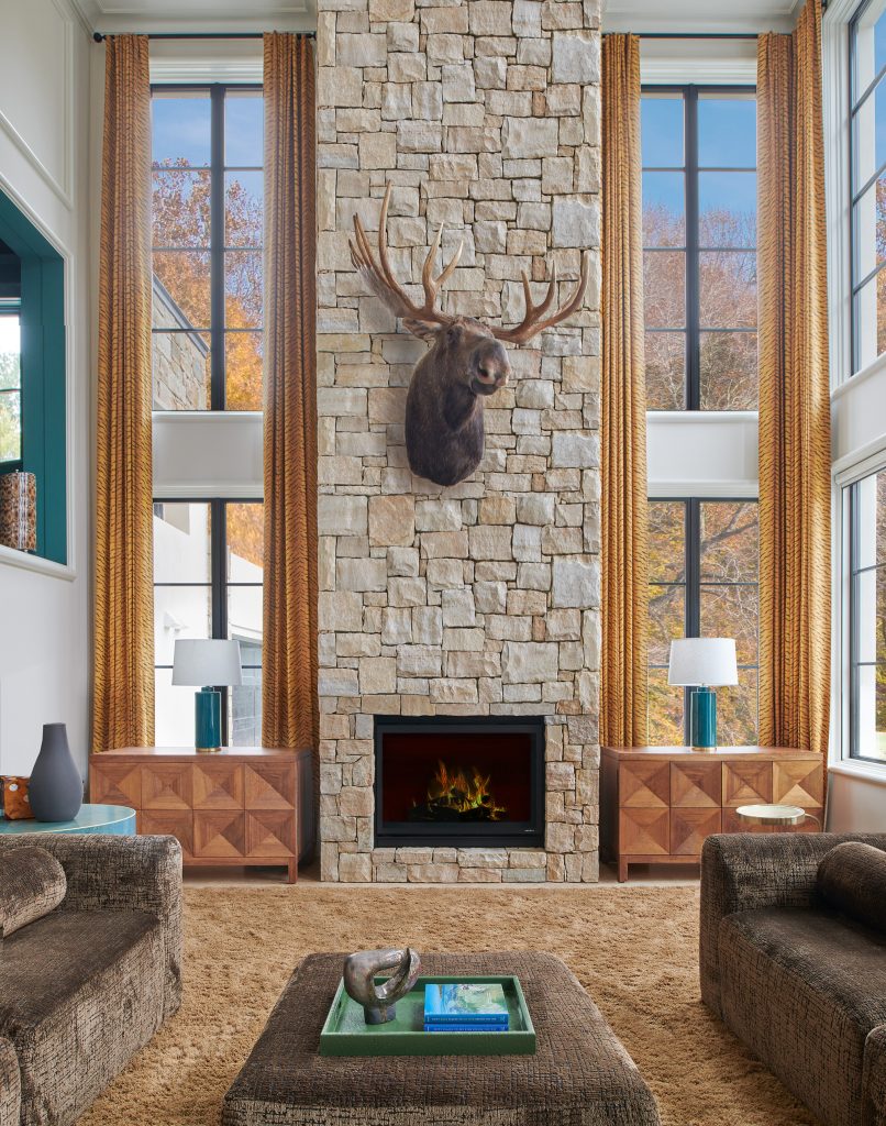 Custom front entry remodel featuring tall wood doors, expansive glass, and natural stone details by The Home X.