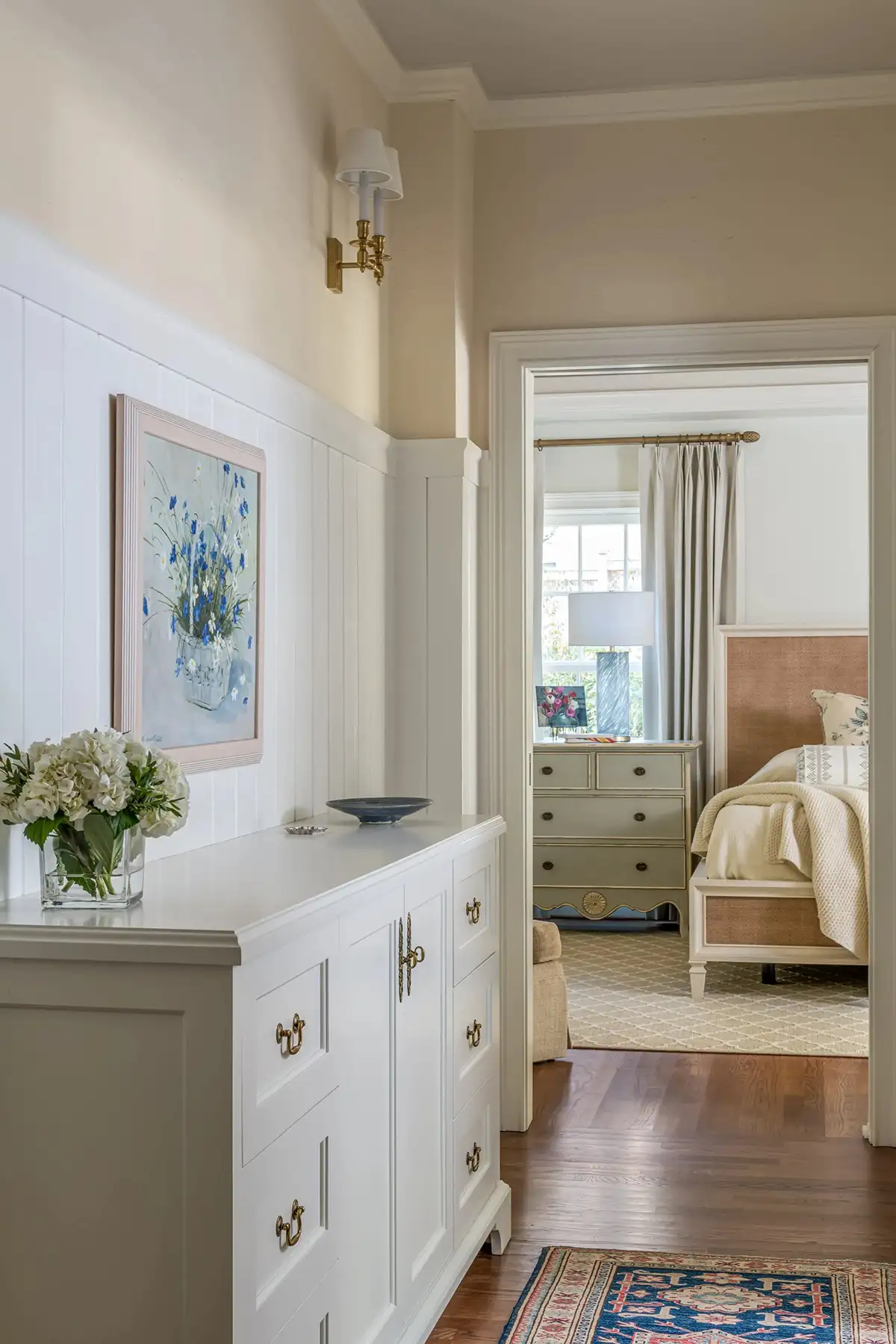 Woodside Rd, Yardley, PA 19067 7 | The Home X Light-filled hallway with white built-in storage, artwork, and a view into the sunroom.