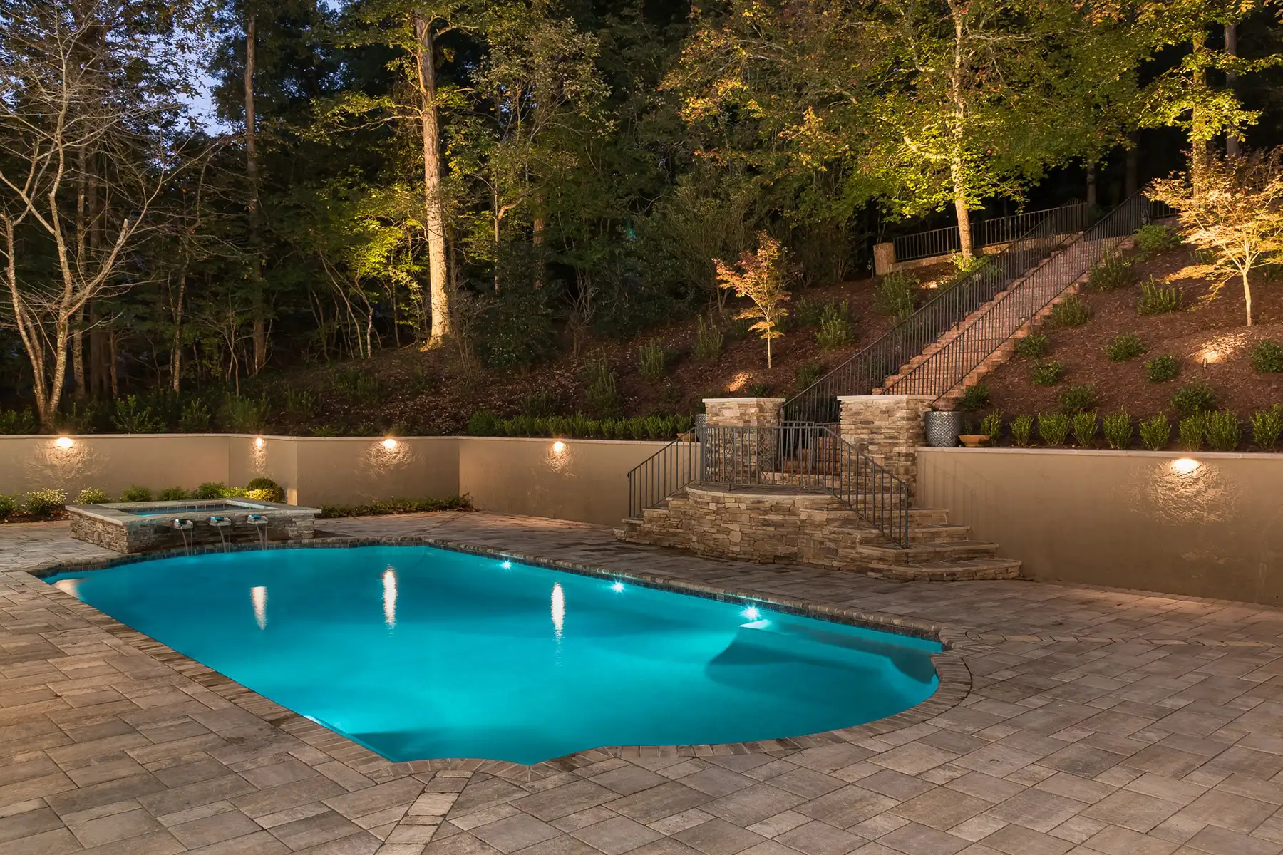Sergeantsville Rd, Delaware Twp., 08559 14 | The Home X Night view of a glowing swimming pool surrounded by trees with soft landscape lighting in Delaware Township.