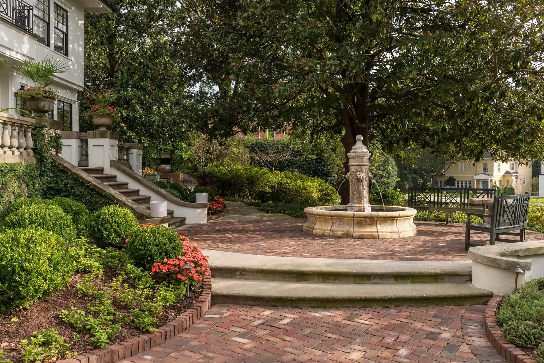 Pidcock Creek Rd, New Hope, PA 18938 15 | The Home X Brick garden steps with a central fountain, surrounded by manicured landscaping and mature trees.