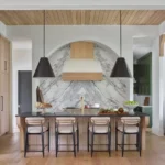 Luxury kitchen remodel in Princeton featuring waterfall quartz island, modern pendant lighting, and custom cabinetry by The Home X.