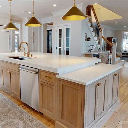 Kitchen Remodel Kitchen island with white oak and greige cabinetry, quartz counters, and under-cabinet lighting in Bucks County home