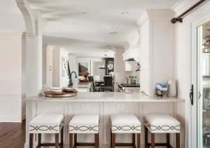 Modern bar with white oak cabinetry, floating shelves, and warm under-cabinet lighting in Princeton, NJ remodel
