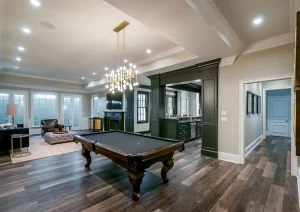 Spacious finished basement with pool table, recessed lighting, and wide plank flooring in New Hope, PA remodel.