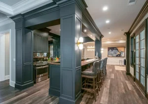 Contemporary home bar with sleek cabinetry, under-cabinet lighting, and wide plank hardwood floors in New Hope, PA basement remodel.