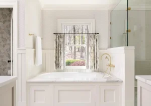 Elegant white bathroom remodel in New Hope, PA with framed mirror and quartz vanity