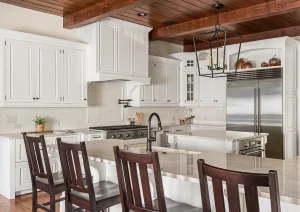 Bright kitchen with exposed beams, white cabinetry, and dark wood island seating in Newtown, PA remodel.