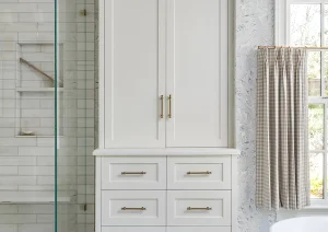 Custom bathroom tower cabinet with drawers and marble tile walls in Princeton, NJ remodel