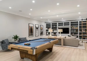 Luxury basement remodel in Newtown, PA featuring custom cabinetry, warm wood tones, and integrated lighting.