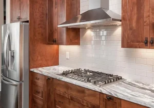Rustic wood kitchen cabinets with stainless range hood and tile backsplash in Lambertville, NJ remodel