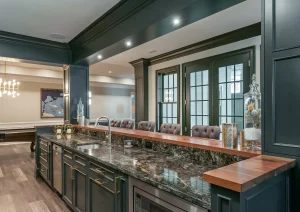 Modern home bar with open shelving, wood accents, and glass cabinetry in a finished basement in New Hope, PA.