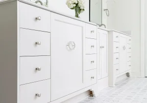 White double vanity with quartz countertop and polished chrome hardware in a luxury bathroom.