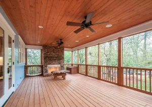 Screened-in porch with wood flooring, ceiling fan, and wooded views in Lambertville, NJ remodel